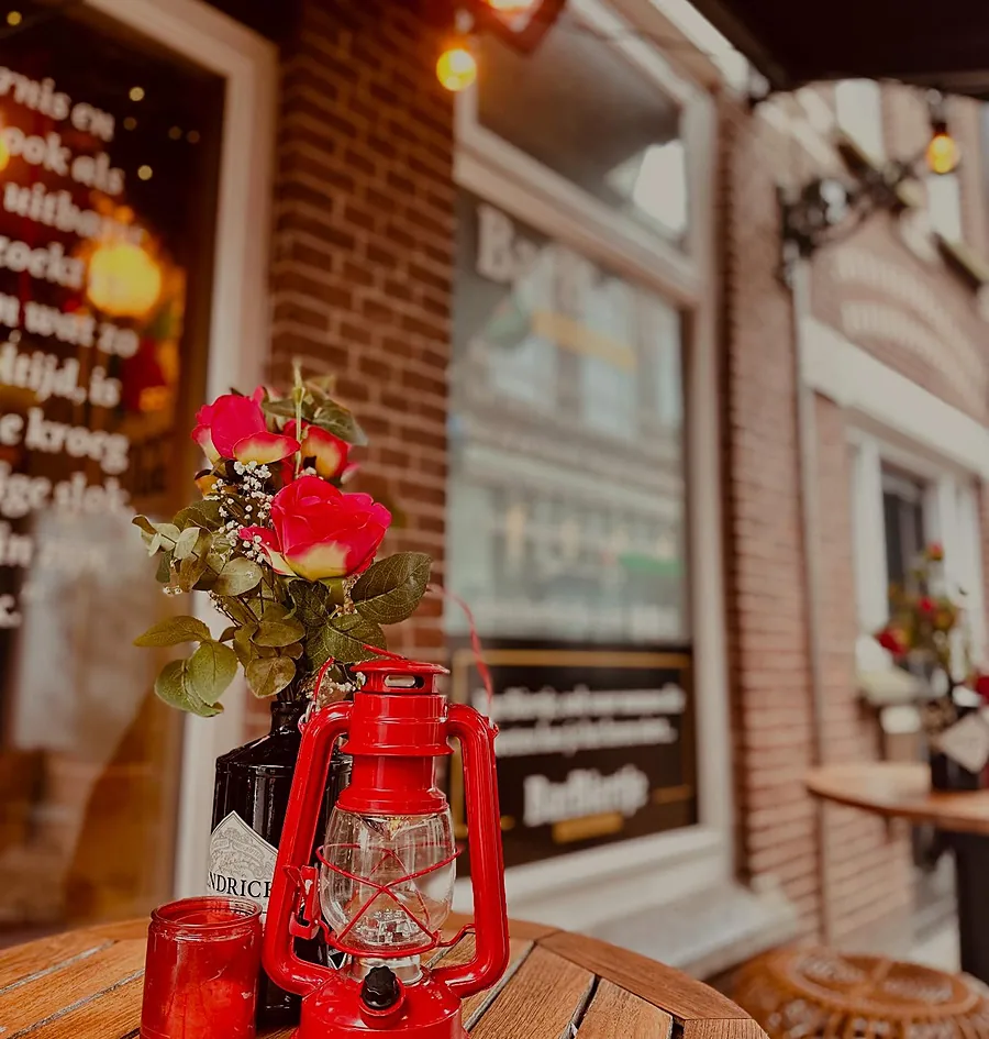 Een tafeltje op het terras met een rode lantaarn